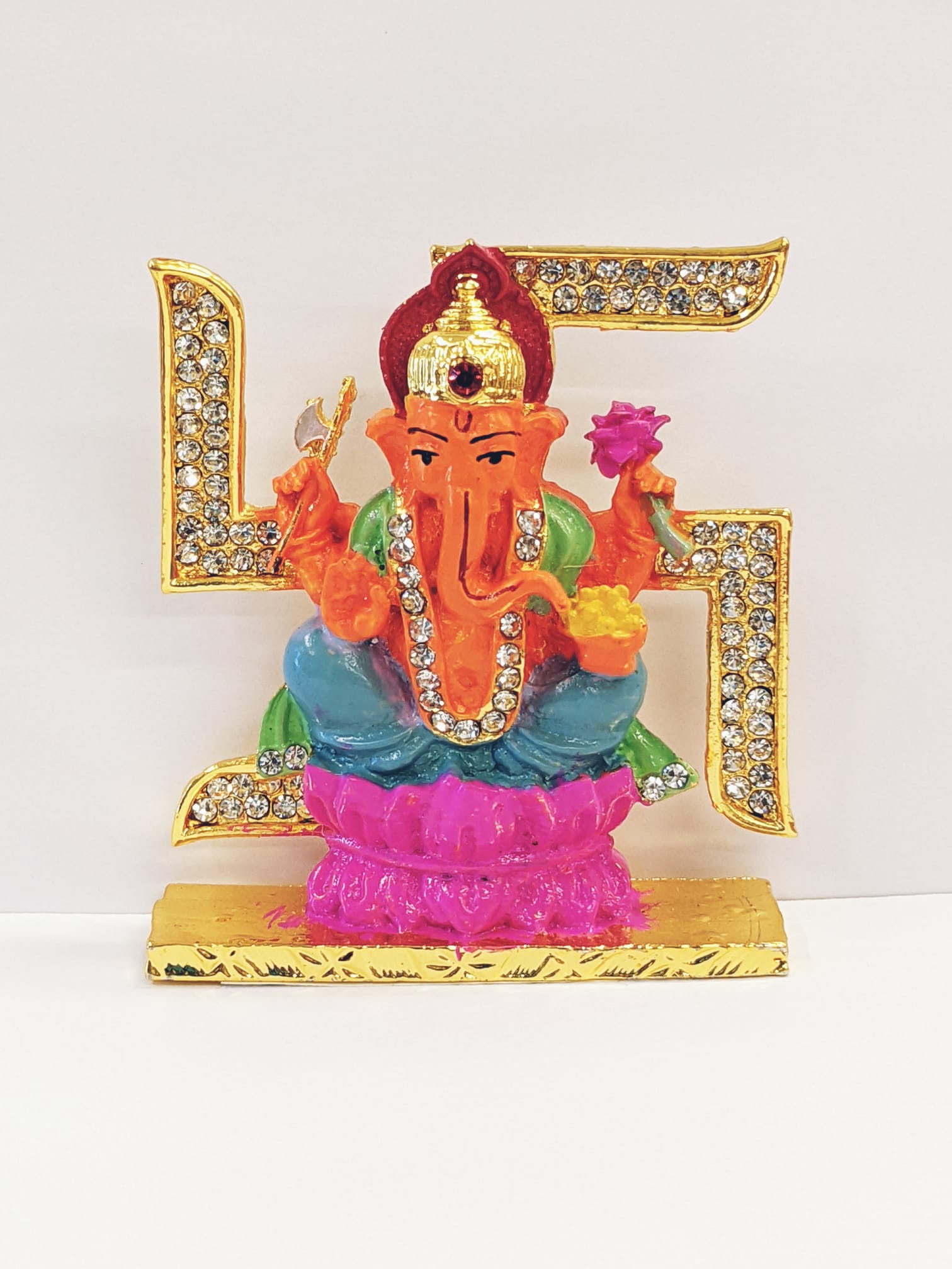 Image of a Car dashboard Idol of Ganesha on swastik, currently ships in Canada and US only