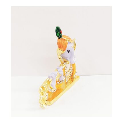 Image of Car dashboard statue of Lord Krishna playing a flute