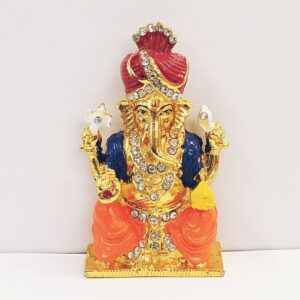 Image of a Car dashboard idol of Ganesha wearing a Pagdi