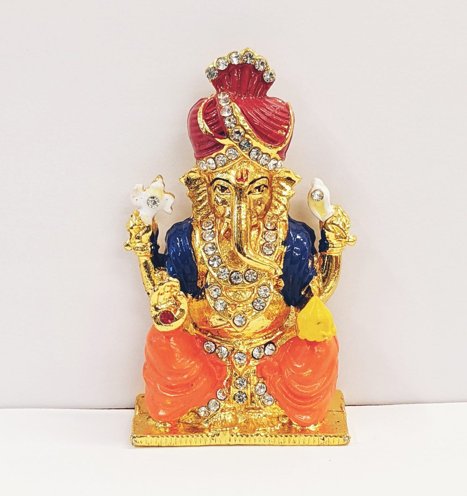 114 Image of a Car dashboard idol of Ganesha wearing a Pagdi