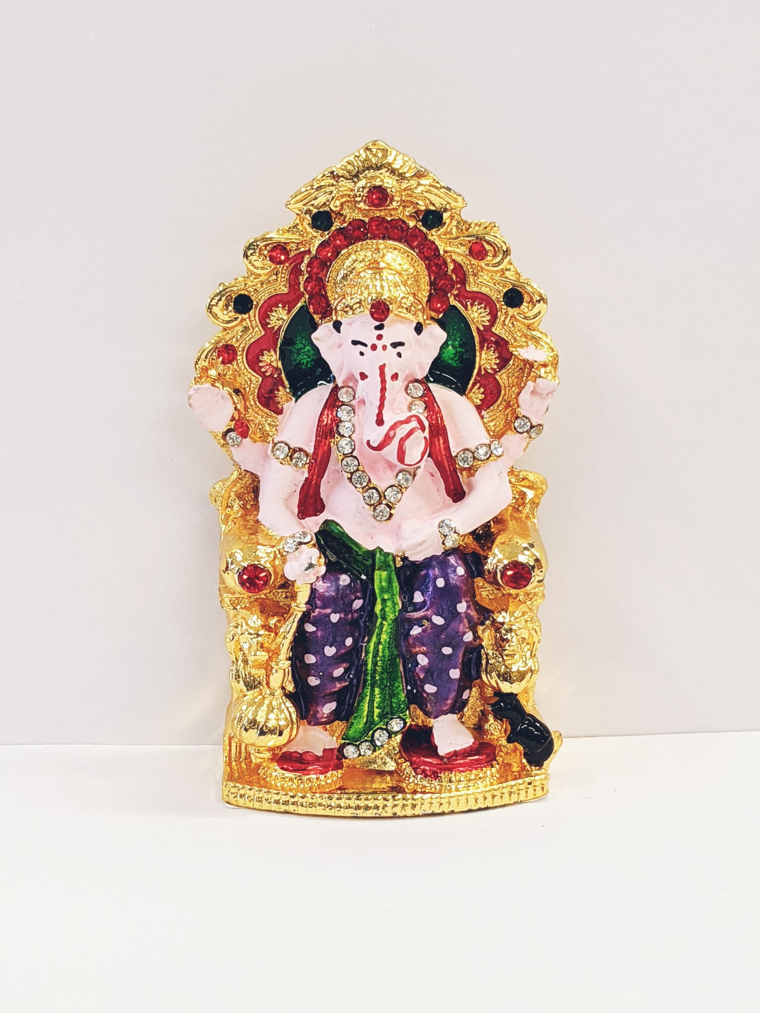 Image of a Car dashboard Idol of Ganesha sitting on a throne