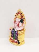 side view Image of a Car dashboard Idol of Ganesha sitting on a throne