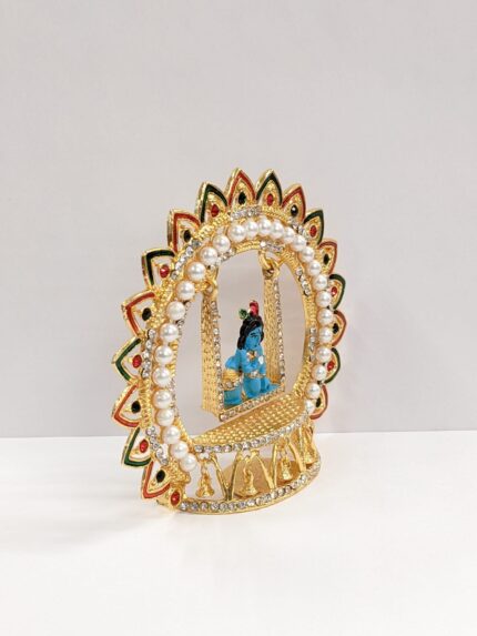 side view of krishna idol on a swing