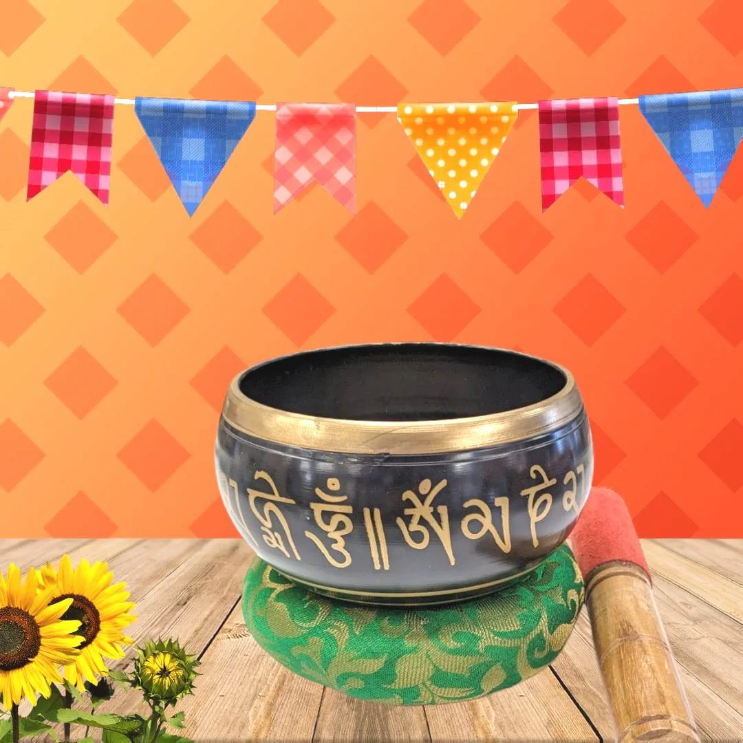 Image of a 5 inch Tibetan Singing bowl with a wooden mallet placed on a Cushion Cover