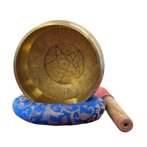 Image of a 6 inch Tibetan Singing bowl with a wooden mallet placed on a Cushion Cover