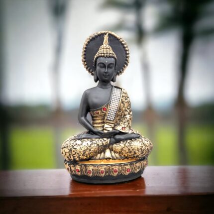 Image of a meditating buddha idol placed on a wooden platform