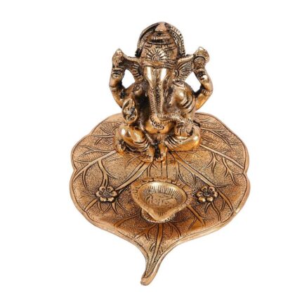 Ganesha on Beetle leaf with a diya in front