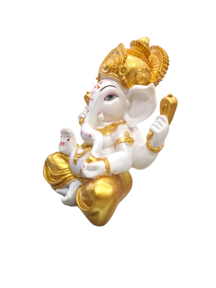 side view Large sized Ganesh Idol with golden dhoti placed on a marble top