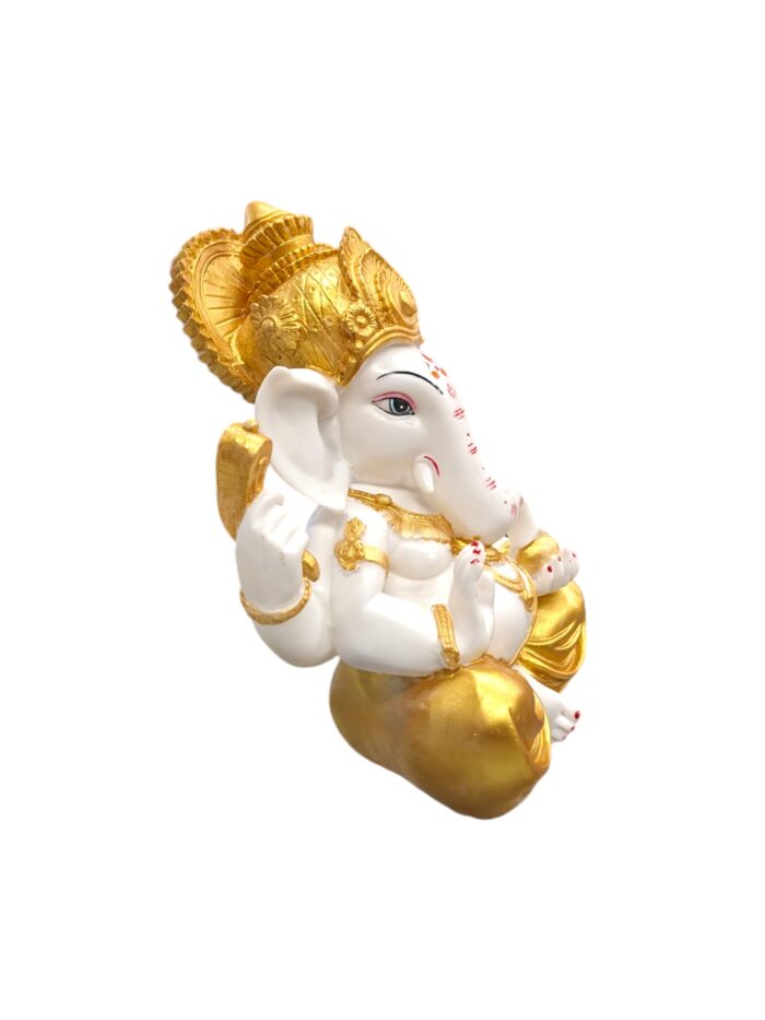 another side view Large sized Ganesh Idol with golden dhoti placed on a marble top