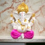 Image of Large Ganesha statue with pink dhoti placed on a marble top