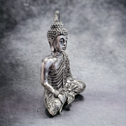 side view Image of a silver oxidized meditating Buddha idol