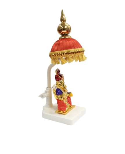 Image of a Car dashboard Idol of Ganesha with a red colored Chattar on top - side view