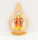 Car Dashboard Idol of Ganesha sitting inside a shell