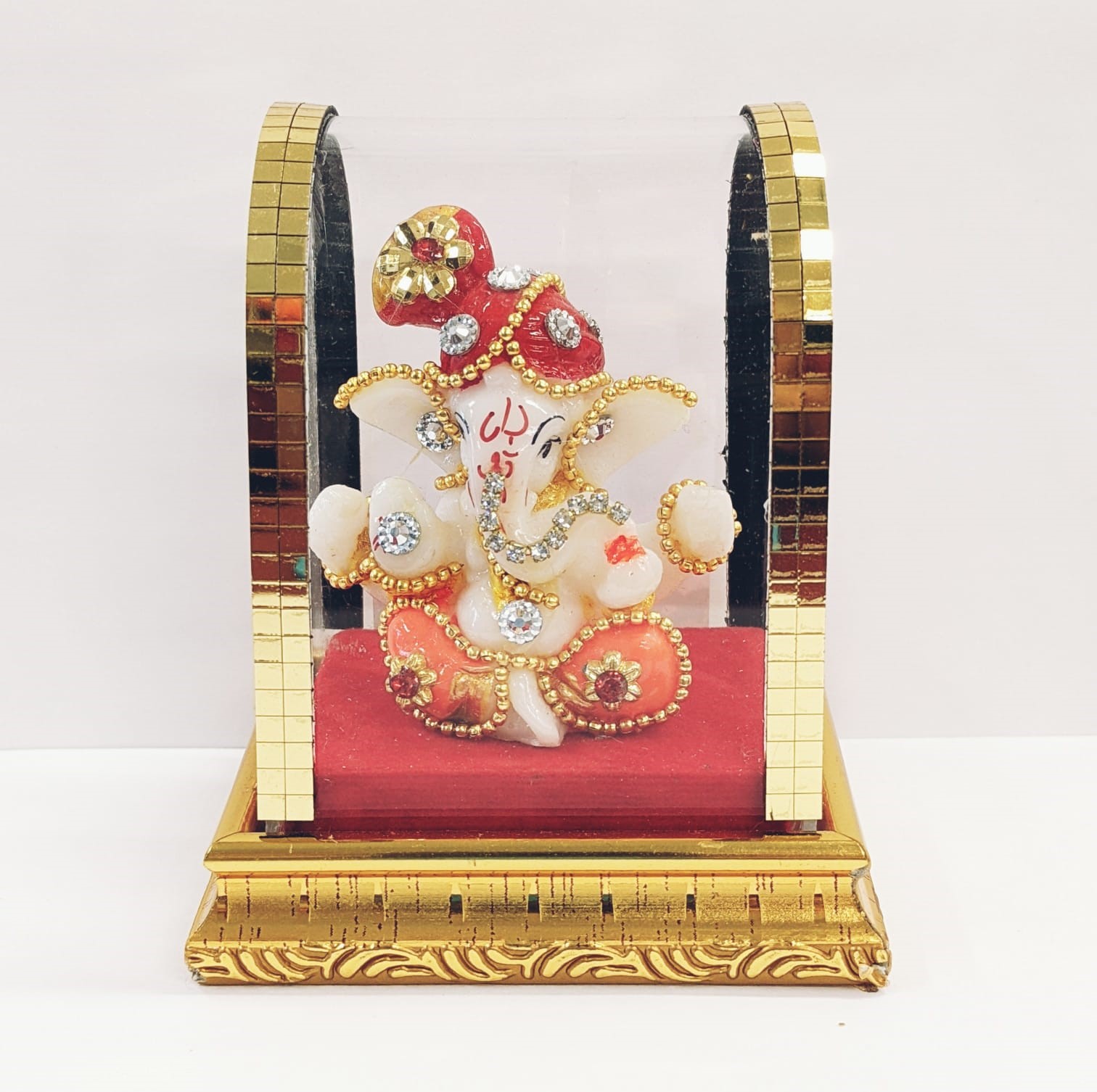 Image of a car dashboard statue of Hindu God Ganesha in a acrylic dome