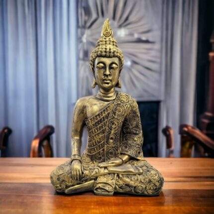 Image of a golden oxidized meditating Buddha statue placed on a wooden platform in a living room setting