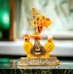 Image of Ganesha Car dashboard Idol holding a veena - orange