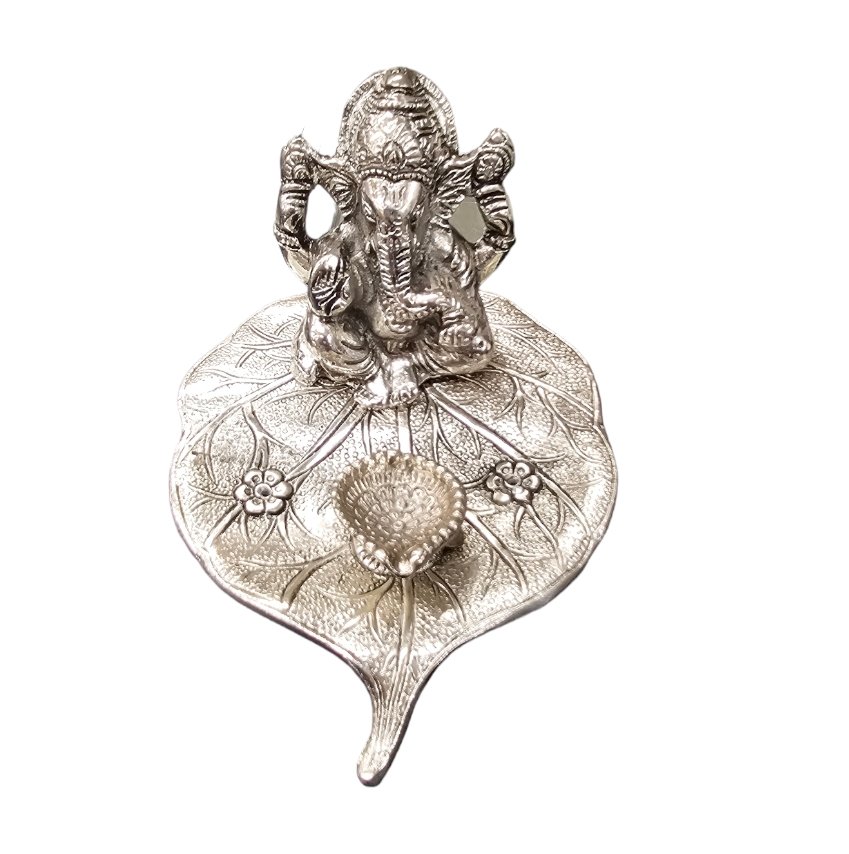 Ganesha on Beetle leaf with a diya in front
