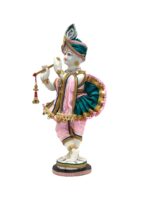 Side view Image of a Large Krishna statue with white body color and beautiful arrangement of clothes on his body.