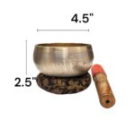 Image of a 4.5 inches Tibetan Singing bowl with a wooden mallet placed on a Cushion Cover