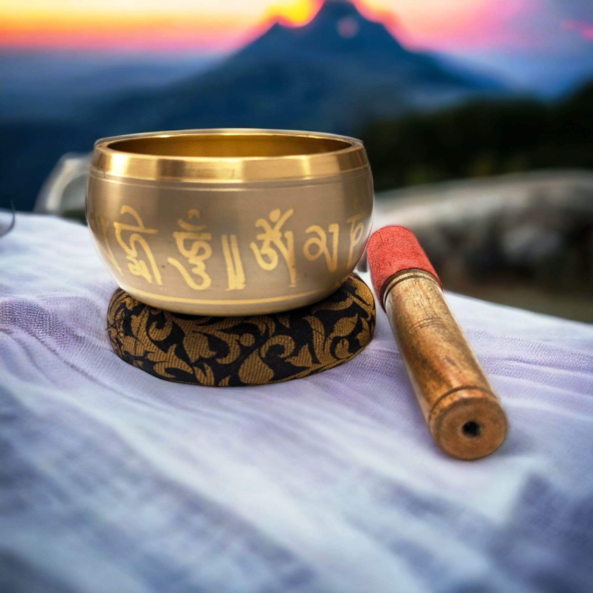 Image of a Tibetan Singing bowl with a wooden mallet placed on a Cushion Cover