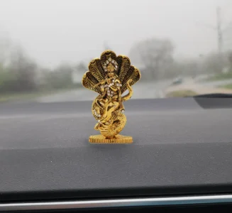 Image of Krishna Car dashboard Idol placed on car dash board