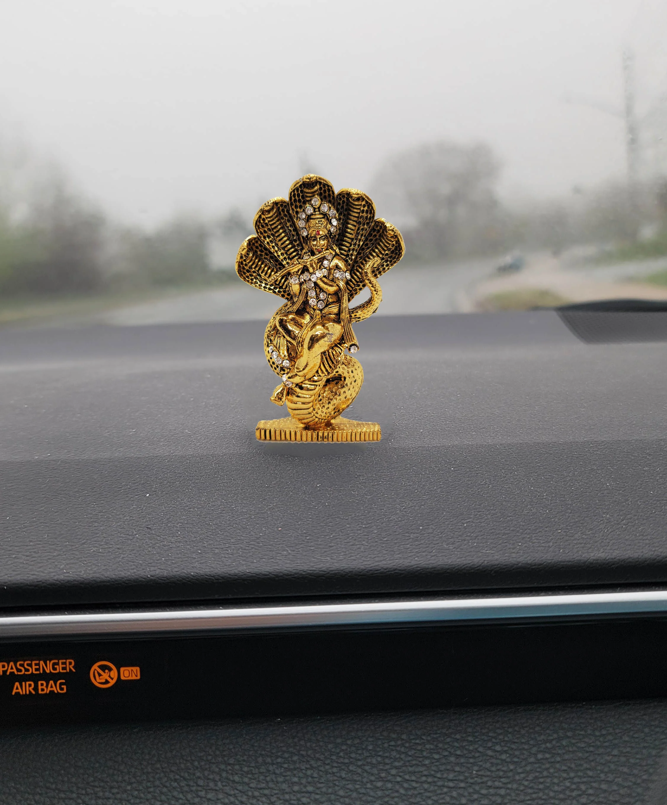 Image of Krishna Car dashboard Idol placed on car dash board