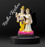 Large idol of Radha Krishna made out of marble dust poly stone with golden hues accent.