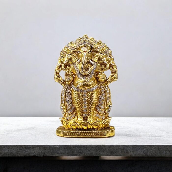 Image of Panchmukhi (five-headed) Ganesh murti. Golden oxidized car dashboard idol