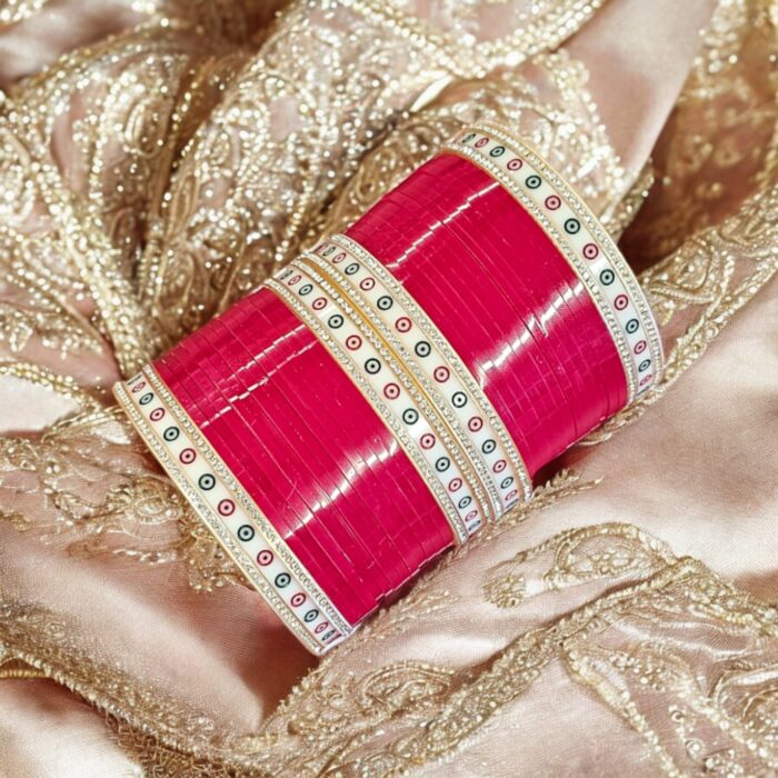 Red Chura with silver gemstones on an embroidered scarf as the background.