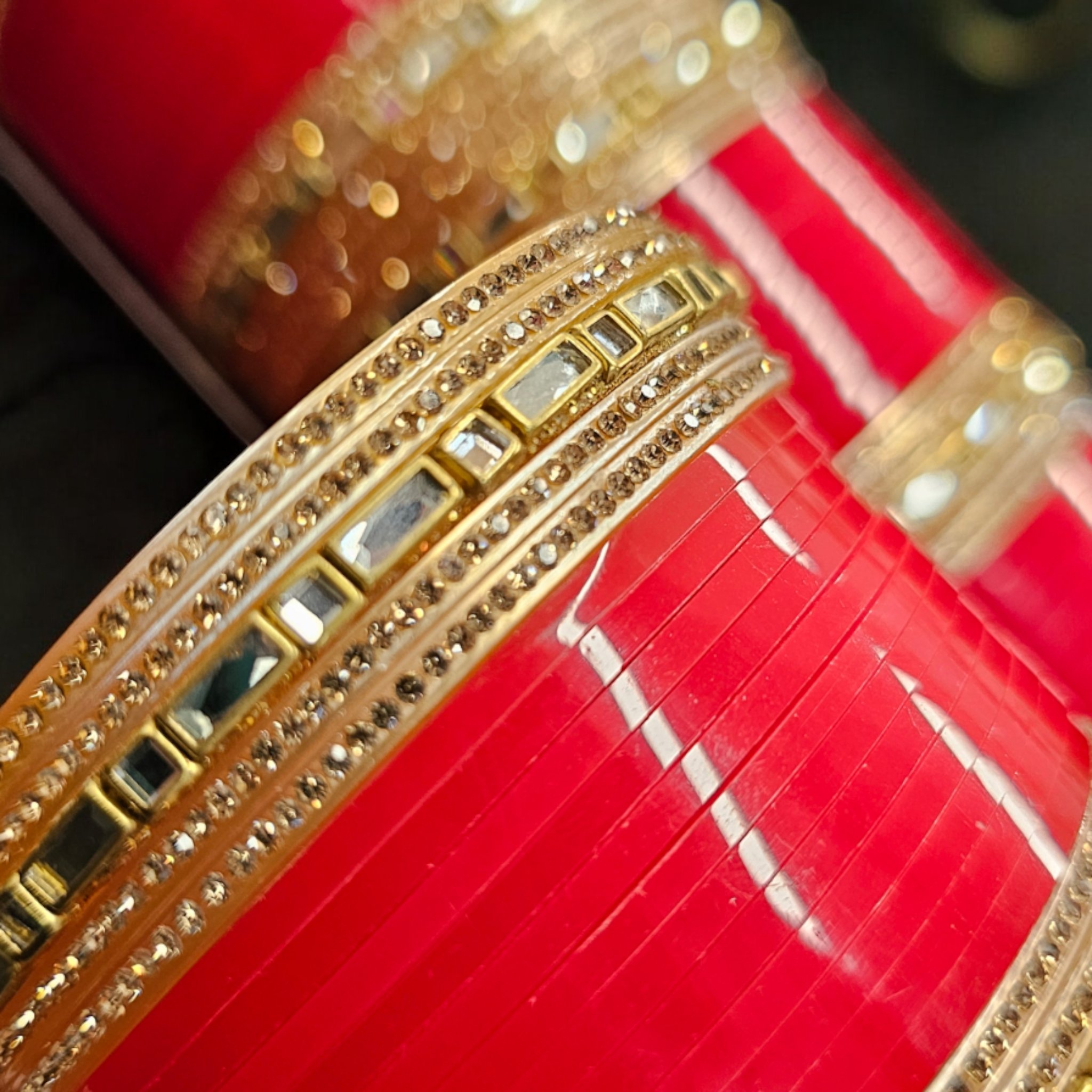 Designer Chura with Kundan work on an embroidered scarf as the background.