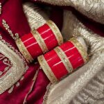 Designer Wedding Chura bangle set with Kundan work on an embroidered scarf as the background.