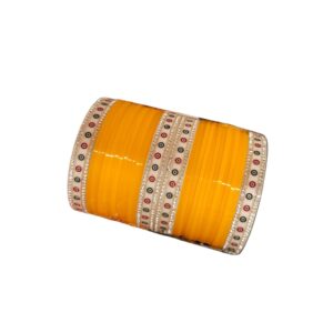 Mango colored Chura with silver gemstones on a white background.