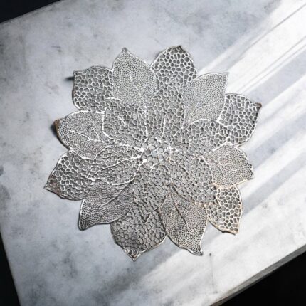 Image of silver accent table mat placed on a white marble . Perfect for everyday use at wholesale prices