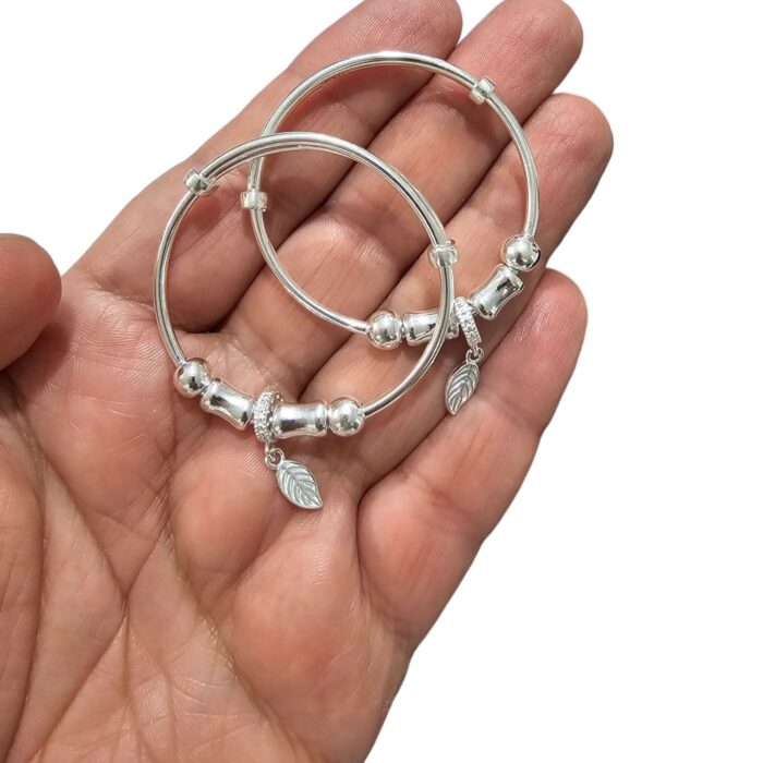 Real feel of the pair of silver bracelet for Baby on an Adult hand