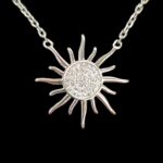 Close up view of the sterling silver sun shaped pendant