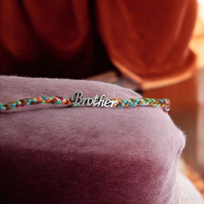 Send Rakhi to USA: Custom gift hamper with Brother emblem Rakhi, chocolates and mithai