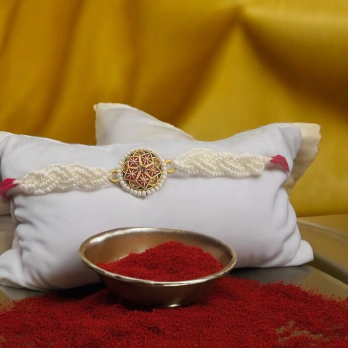 Elegant pearl and thread Rakhi for brother with gold accents