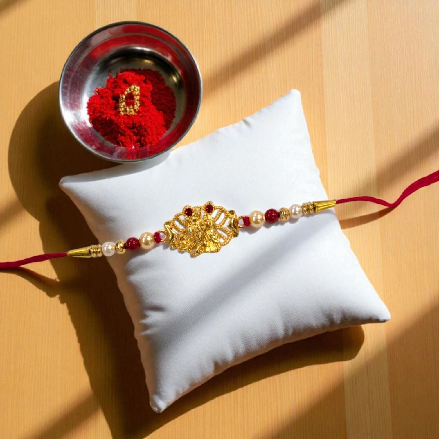 Elegant Radha Krishna Golden Rakhi Elegant Radha Krishna Golden Rakhi with kumkum and Indian sweets hamper