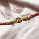 Simple yet elegant Golden oxidized premium Rakhi with Ganesh