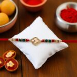 Send Rakhi to Canada: Elegant beaded band with cz stone emblem