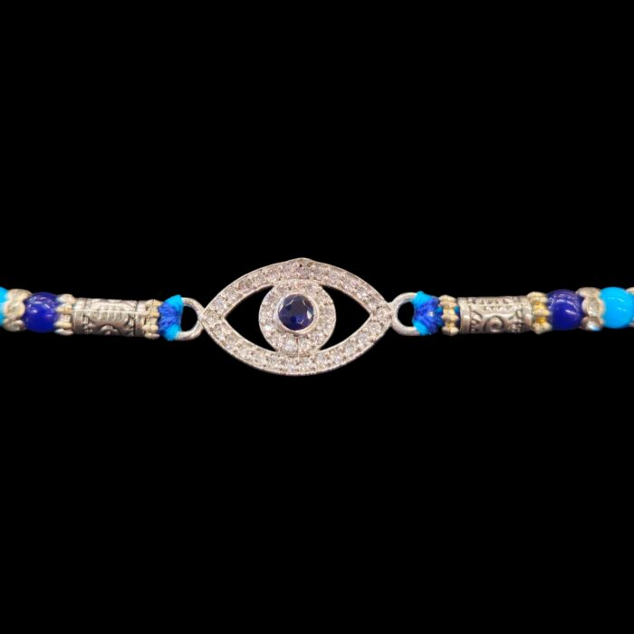 Close-up of evil eye charm on sterling silver Rakhi | Send this pure silver Rakhi to Canada / USA