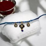 Our dazzling evil eye Rakhi feature nazarbattu charms that catch the light and ward off negative energy for your brother | Rakhi delivery USA | Ship rakhi to Canada