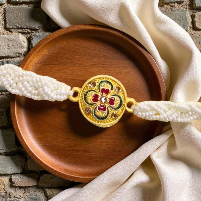 Elegant pearl and thread Rakhi for brother with gold accents