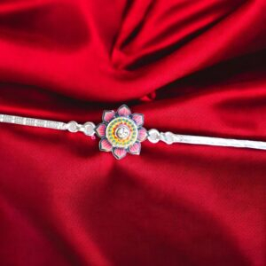 Close up of Stylish silver plated Rakhi with meena work flower in Canada /US