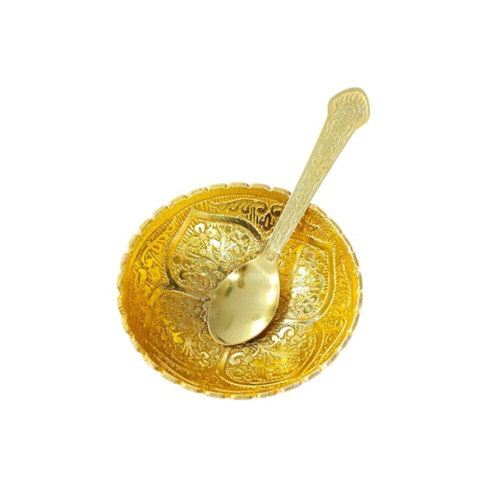 Close up of gold plated bowl and spoon set
