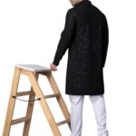 Back profile view of a model wearing the black kurta