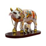 Side profile view of hand painted Kamdhenu Idol