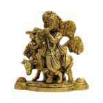 Detailed close-up of a handcrafted pure brass Lord Krishna with cow statue.