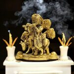 Solid brass statue of Lord Krishna with a cow, handcrafted for worship and home decor.