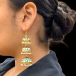 Model wearing 3 Tier Meena Jhumki earrings
